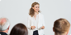 Woman standing talking to an audience