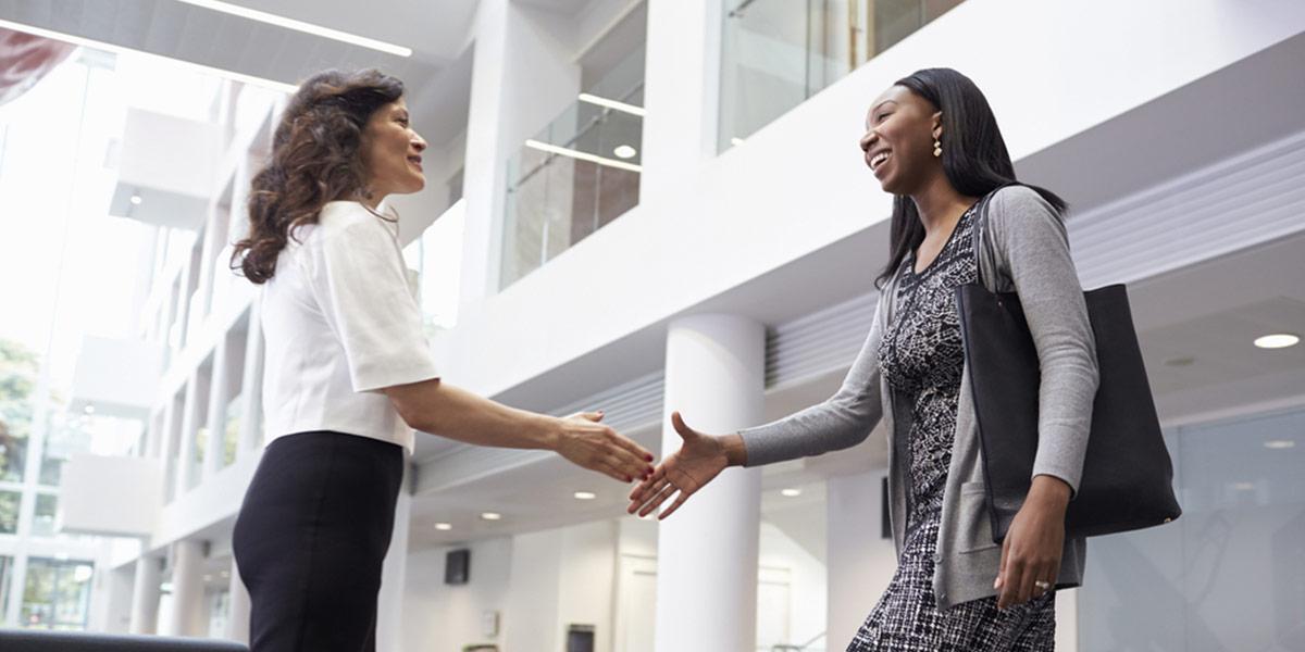 Two women shaking hands