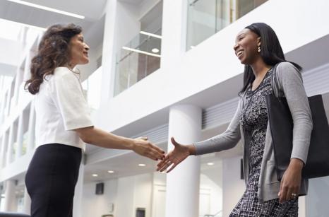 Two women shaking hands